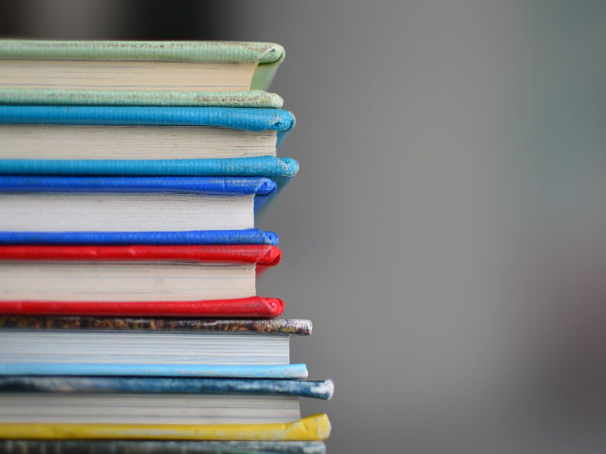 Stack of books for article 10 Best School Districts in Tucson for newcomers moving to Tucson.