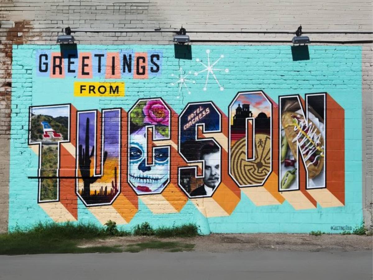 Street art mural that is part of the Street Art Tours and depicts the words greetings from TUCSON with each letter having images painted inside of them for article What's new to Tucson in 2025 for newcomers moving to Tucson.