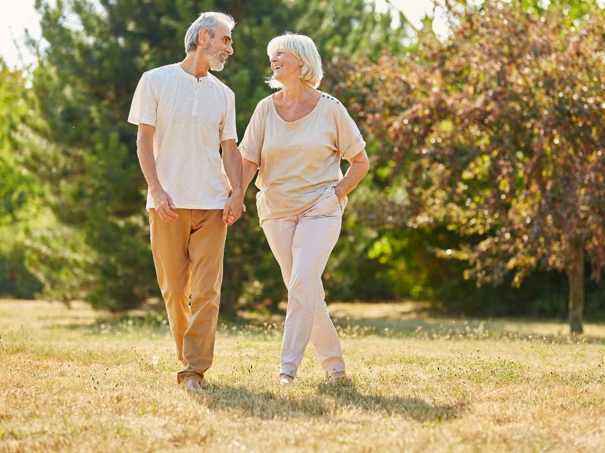 Senior couple walking outside holding hands for article Senior Living in Tucson for newcomers retiring in Tucson.