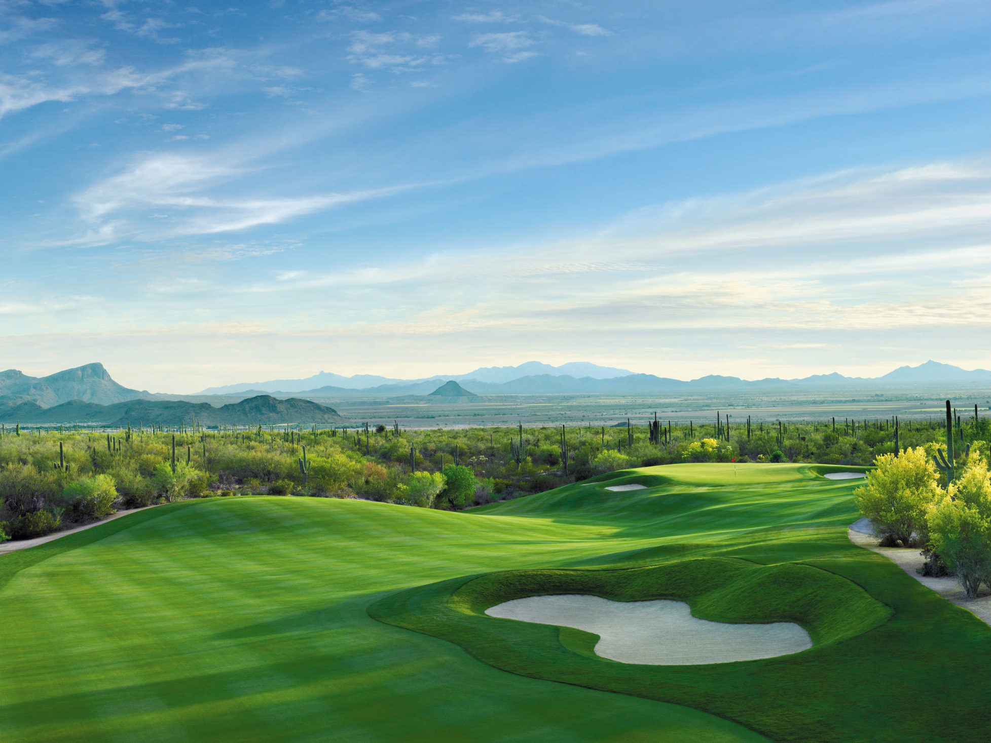 Sunny afternoon view of a golf course hole named Dove Mountain in Tucson, AZ.