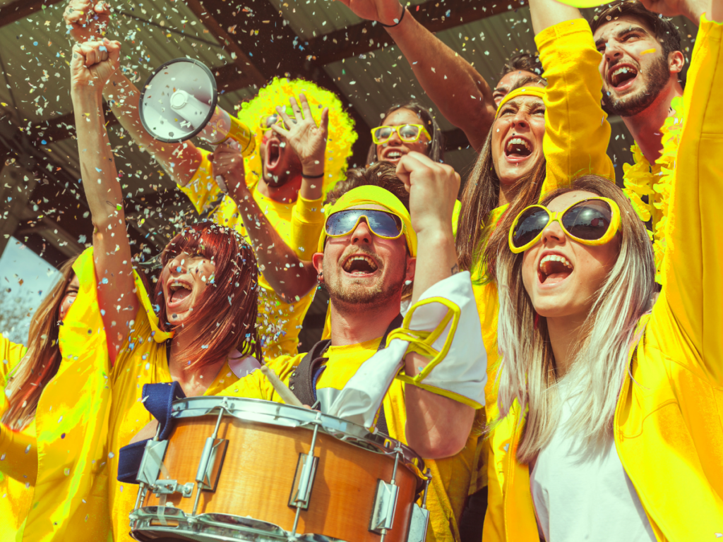 Crowd cheering at a sporting event.