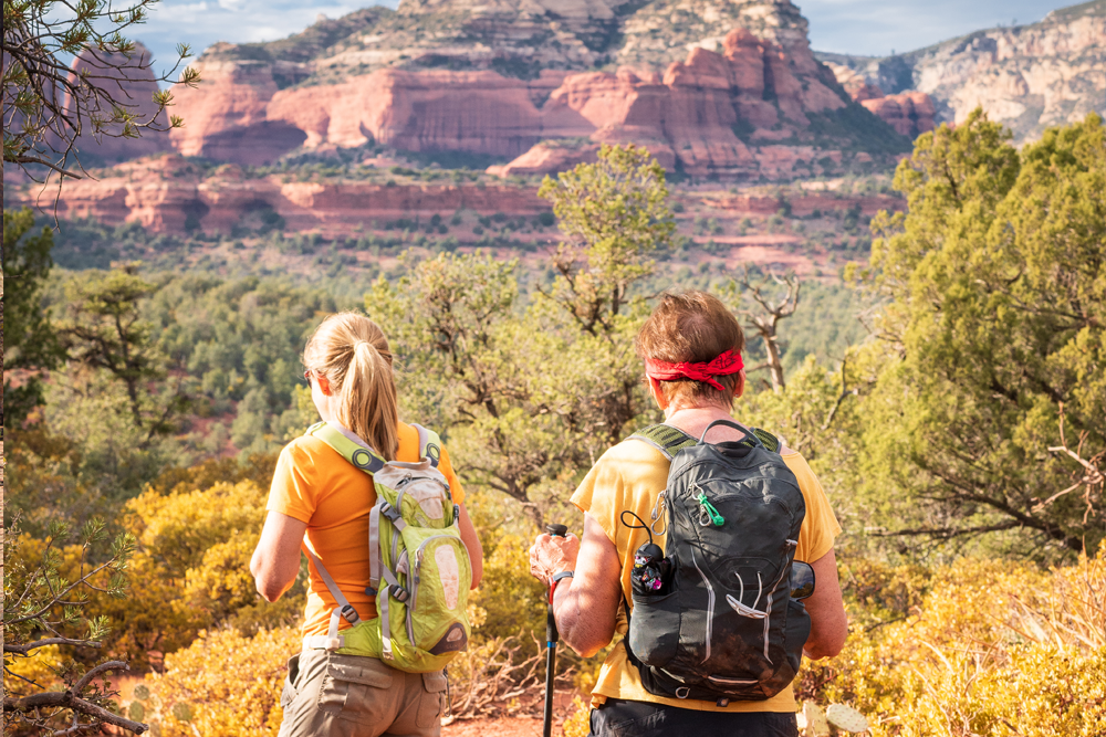 Two people hiking through Tucson dessert landscape