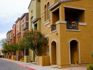 Row of homes in Tucson in sandy yellows, greens , oranges to represent the article - A Newcomer’s Guide to the 5 Best Neighborhoods in Tucson