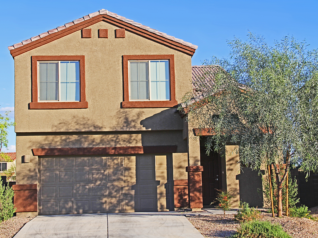 Sandy colored home with terra cotta trim in Tucson for article on Places With a Low Cost of Living in Tucson.