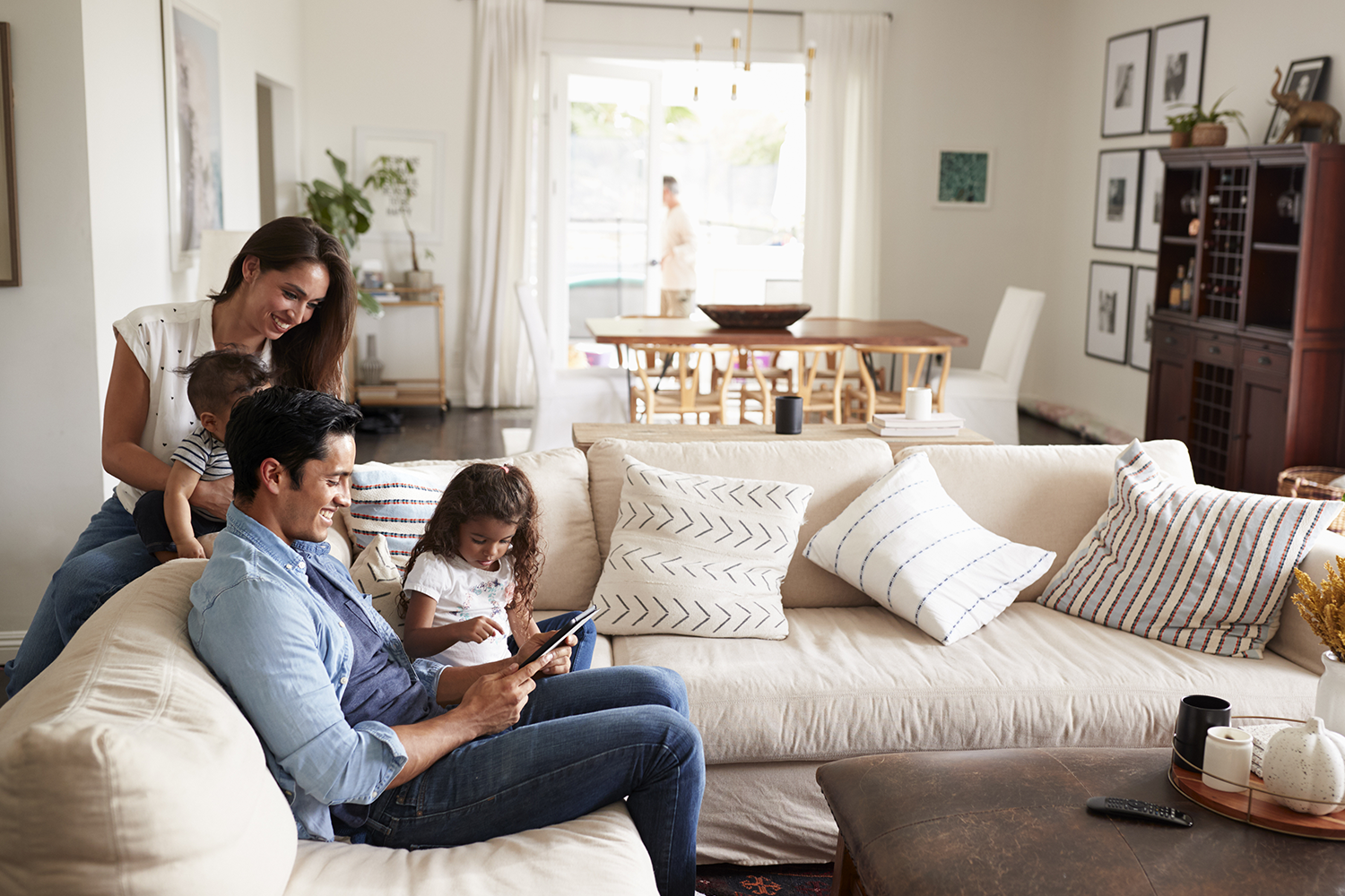 Department graphic: Family looking at computer on couch