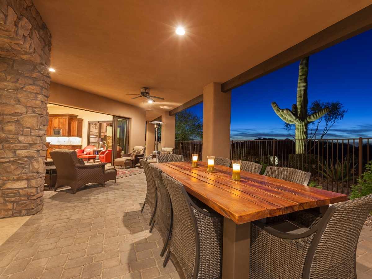 Large open concept covered patio in the evening looking out to a beautiful desert view for article Buying a Home with a View in Tucson: Best Neighborhoods and Tips